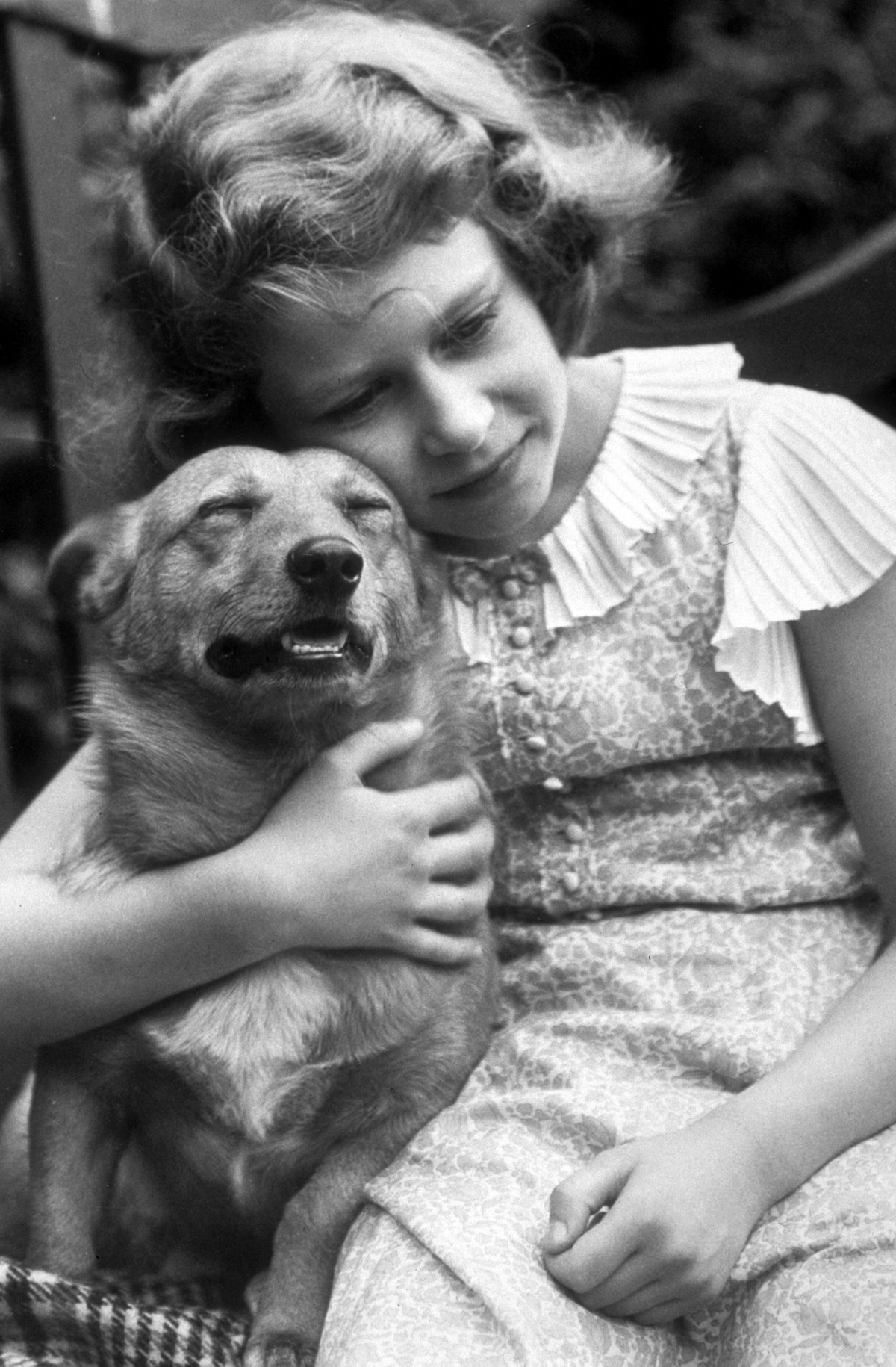 July 1936:  Princess Elizabeth hugging a corgi dog.  (Photo by Lisa Sheridan/Studio Lisa/Hulton Arch...