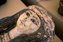 This picture taken on May 30, 2022 shows the face on one of the sarcophaguses found in a cache datin...