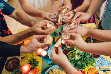 Friends having Mexican food, for which they'll need cinco de mayo captions for Instagram.