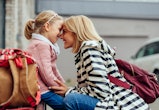 Lovely moments of beautiful mother and her preschool daughter in front of school