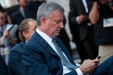 NEW YORK, NY - SEPTEMBER 14:   New York City Mayor Bill de Blasio checks his phone during an event t...