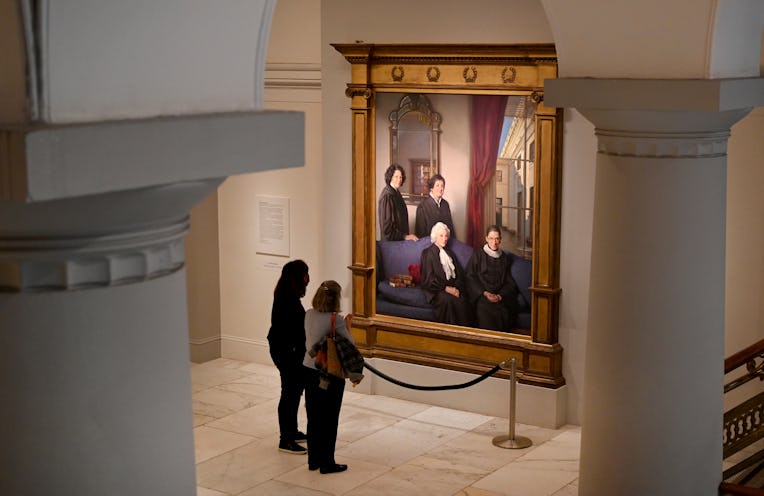WASHINGTON, DC - NOVEMBER 15: 
Women pause in front of The Four Justices, a portrait by Nelson Shank...