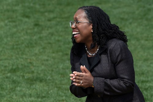 Judge Ketanji Brown Jackson laughs as US President Joe Biden speaks at an event celebrating Jackson ...