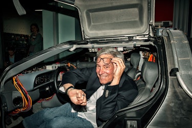 LOS ANGELES, CA - APRIL 20:  Writer Bob Gale sits inside the Delorean at the "Back To The Future" We...