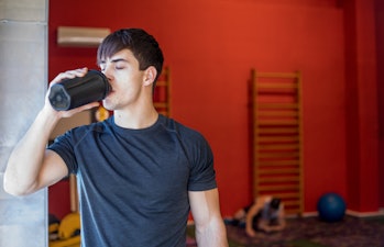 Young Man D.rinking Protein Shake During Training