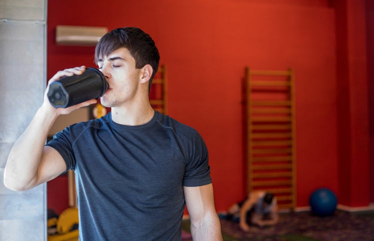 Young Man D.rinking Protein Shake During Training