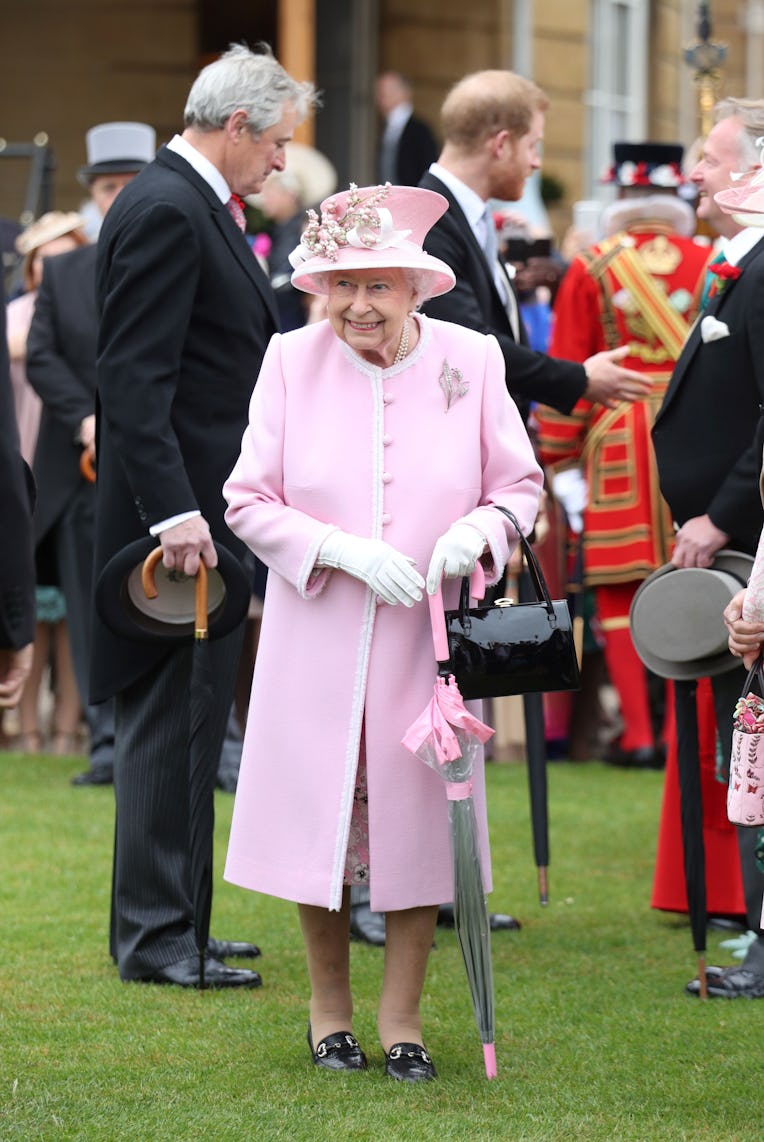 Britain's Queen Elizabeth II and Britain's Prince Harry, Duke of Sussex greet guests at the Queen's ...