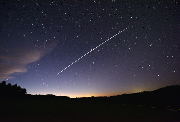 TOPSHOT - This long-exposure image shows a trail of a group of SpaceX's Starlink satellites passing ...