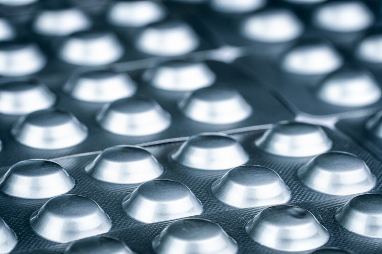 Tablets pill in silver aluminium foil blister pack. Pharmaceutical industry.  Many of blister packag...