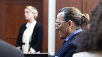 US actress Amber Heard (L) testifies as US actor Johnny Depp looks on during a defamation trial at t...