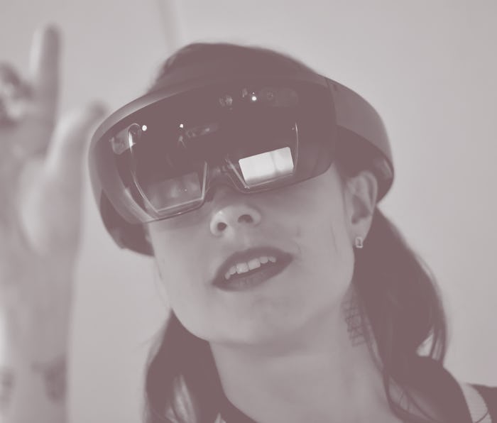 A young woman looks through a Microsoft hololens at the labore:tory at the internet conference re:pu...