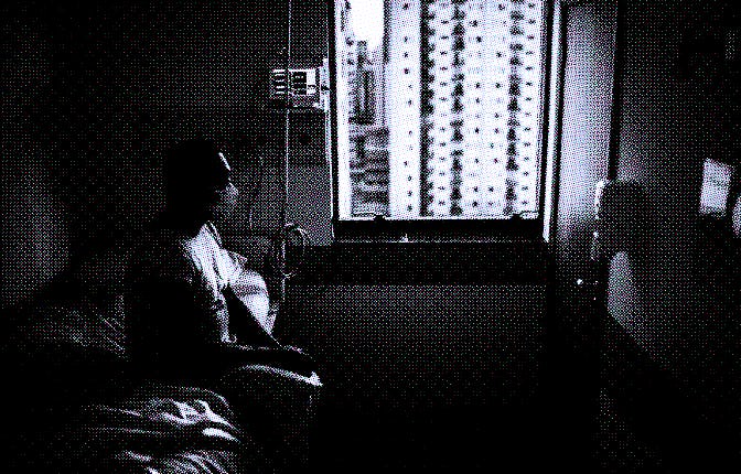 Senior patient using mask looking through window at hospital