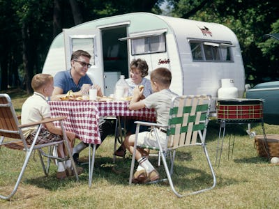 1960s FAMILY CAMPING TRAILER RV PICNIC LAWN CHAIR BBQ GRILL  (Photo by H. Armstrong Roberts/ClassicS...