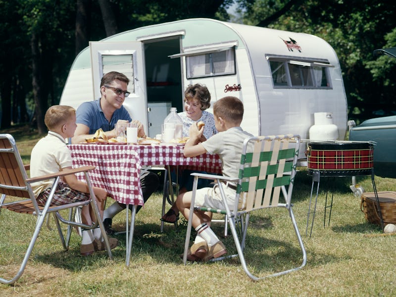 1960s FAMILY CAMPING TRAILER RV PICNIC LAWN CHAIR BBQ GRILL  (Photo by H. Armstrong Roberts/ClassicS...