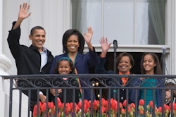 US President Barack Obama waves alongside First Lady Michelle Obama, their daughters Sasha(R) and Ma...