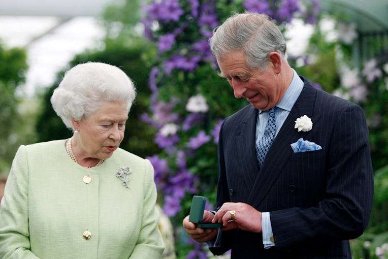 Britain Queen Elizabeth II presents to Prince Charles with a Royal Horticultural Society's Victoria ...