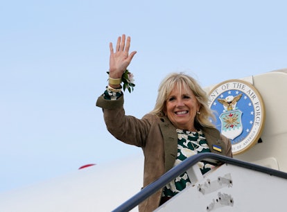 US First lady Jill Biden wears a large Ukrainian badge on her jacket as she waves from the top of th...