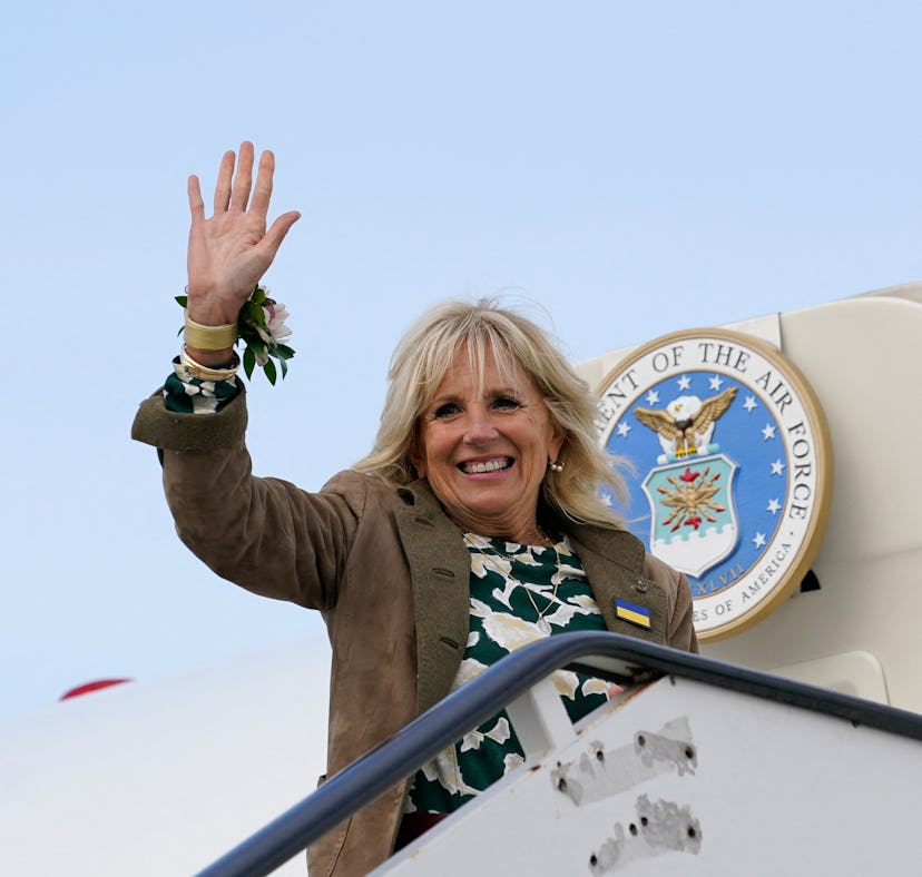 US First lady Jill Biden wears a large Ukrainian badge on her jacket as she waves from the top of th...