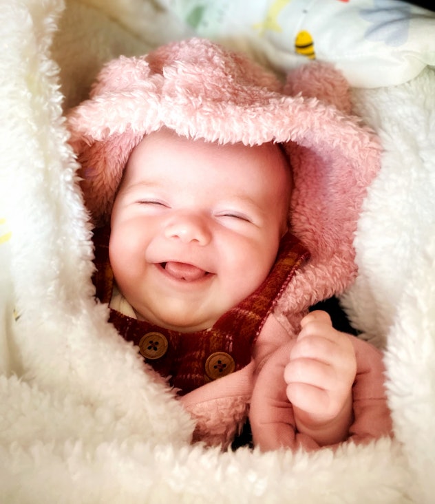 Six week old baby girl in fluffy blanket and winter clothing might have a short middle name.