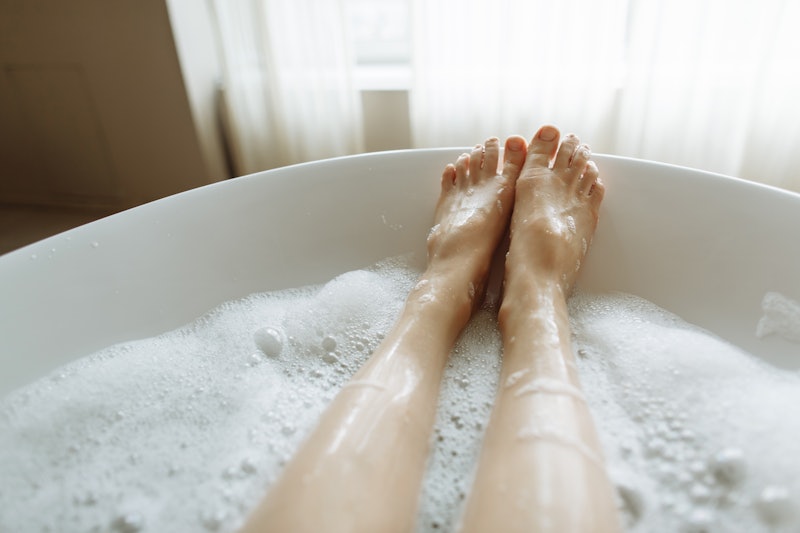 Woman's feet in bubble bath