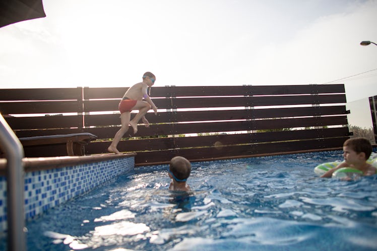 A child jumping into a pool.