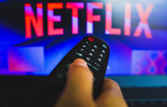BRAZIL - 2022/05/10: In this photo illustration, a hand holding a TV remote control in front of the ...