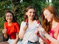 three young women enjoy popsicles as they chat about the June 2022 full moon in Sagittarius.