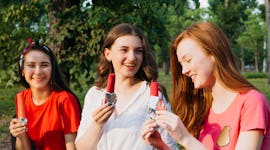 three young women enjoy popsicles as they chat about the June 2022 full moon in Sagittarius.