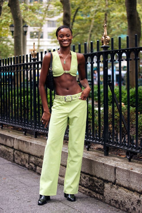 Model Mayowa Nicholas wears a matching green bra crop top and pants.