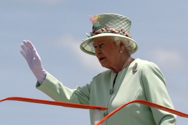 Britain's Queen Elizabeth II waves as she exits a Royal Australian Air Force airplane after arriving...