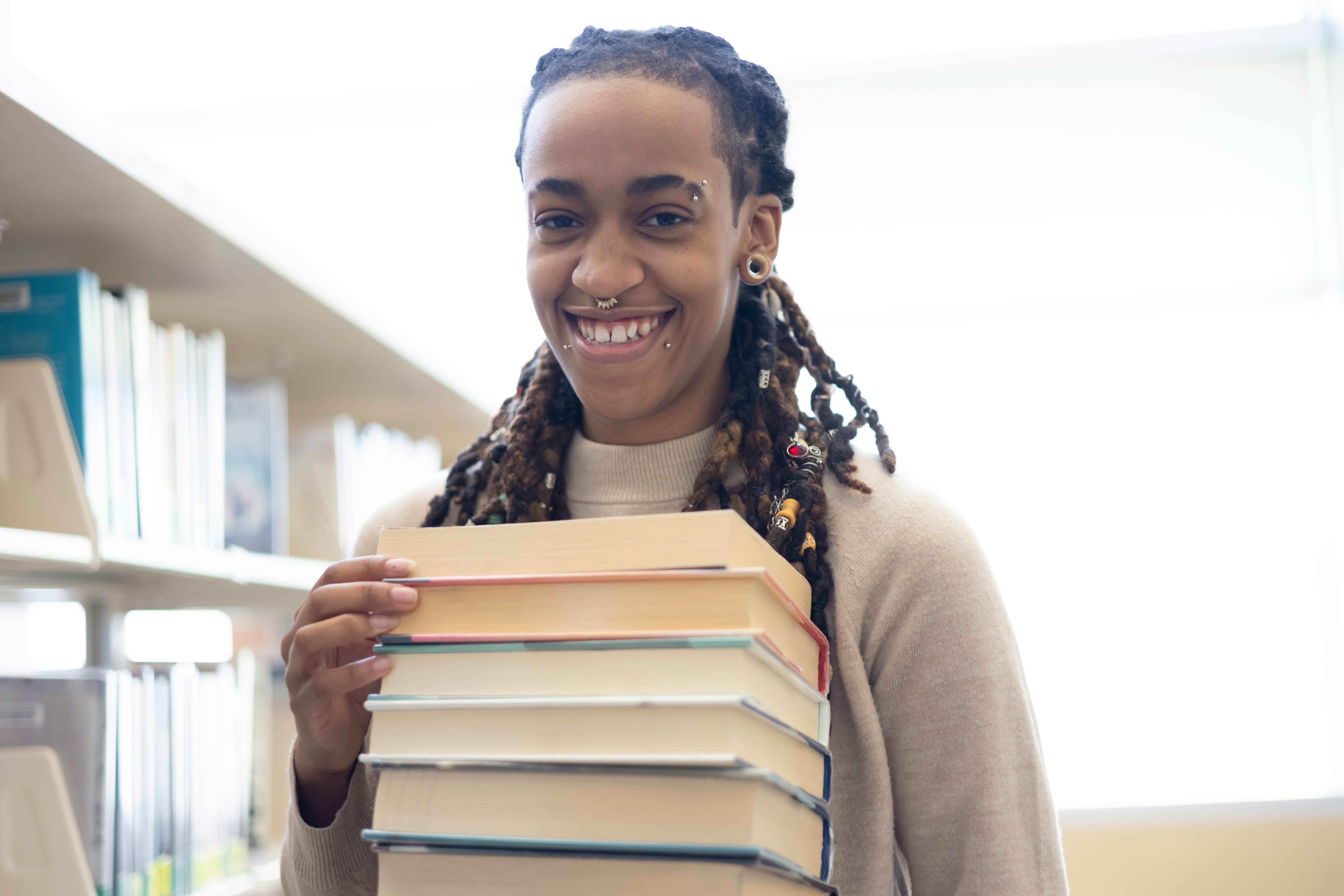 A young woman using a public library. Could also pass as a College or School Library.