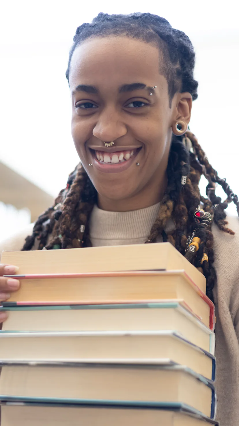 A young woman using a public library. Could also pass as a College or School Library.