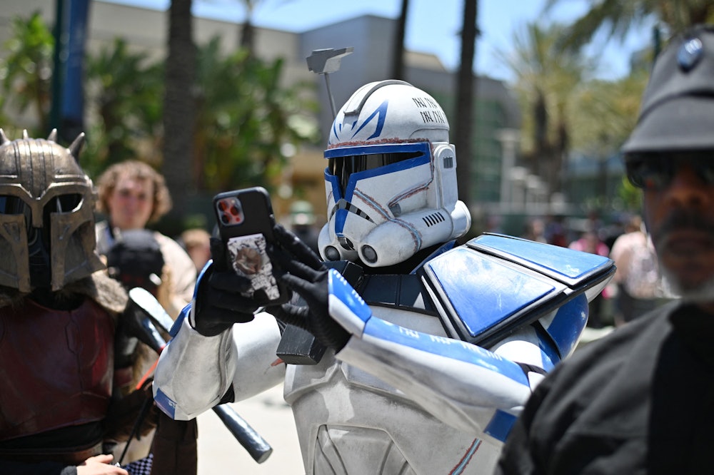 TOPSHOT - A Star Wars fan cosplaying Captain Rex, takes a photo with his phone while attending the f...