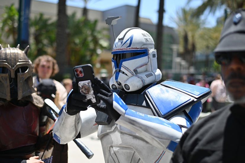TOPSHOT - A Star Wars fan cosplaying Captain Rex, takes a photo with his phone while attending the f...