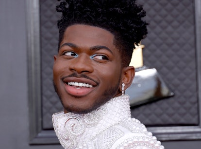 Lil Nas shows off short hair at the Grammys very different from his current long, blond hair reminis...