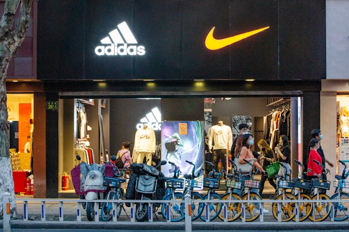 HANGZHOU, CHINA - MARCH 28: Logos of Adidas and Nike are seen on a sports clothing store on March 28...