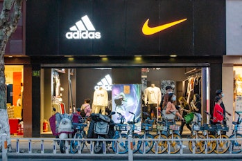 HANGZHOU, CHINA - MARCH 28: Logos of Adidas and Nike are seen on a sports clothing store on March 28...