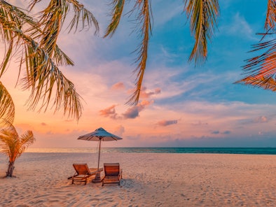 Beautiful beach. Chairs on the sandy beach near the sea. Summer holiday and vacation concept for tou...