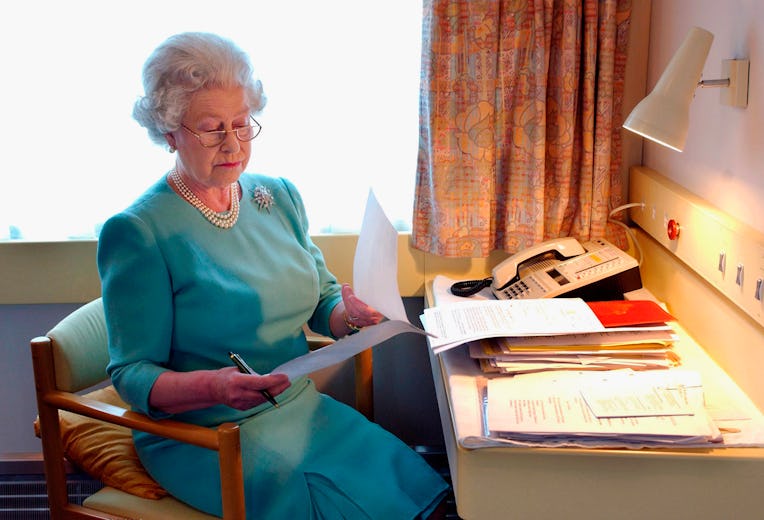 UNSPECIFIED LOCATION - MAY: Queen Elizabeth II works at her desk on the Royal Train in May of 2002.(...