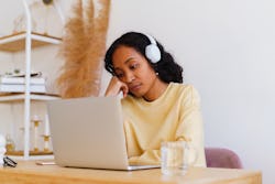 A woman stares forelornly at her laptop. Here's your june 14 zodiac sign daily horoscope.