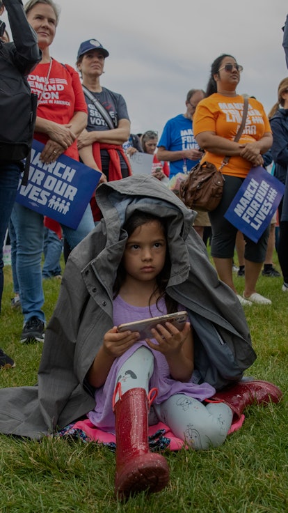 WASHINGTON, D.C. - June 11: Cora Purekal, 5, takes a break at the March for our Lives rally against ...