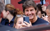 CANNES, FRANCE - MAY 18: Tom Cruise poses with a fan for a selfie after leaving the photocall of "To...