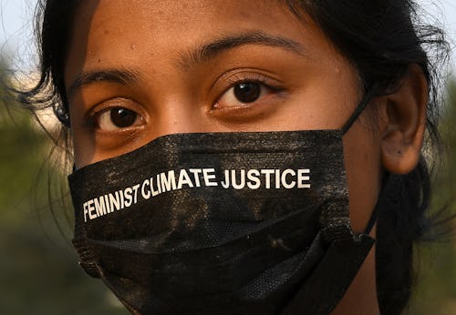 MUMBAI, MAHARASHTRA, INDIA - 2022/03/26: A woman wearing a protective facemask with a climate messag...
