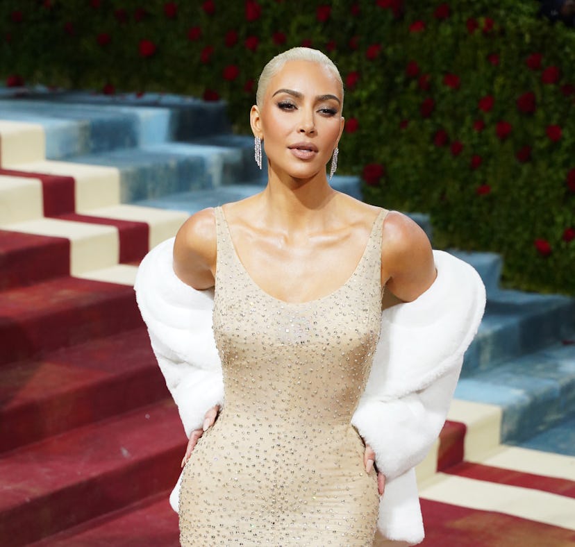 Kim Kardashian wearing Marilyn Monroe's 1962 dress which appears damaged in before and after photos.