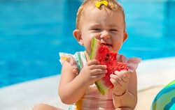 Baby is eating a watermelon by the pool, summer baby girl names
