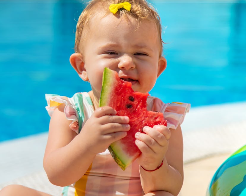 Baby is eating a watermelon by the pool, summer baby girl names