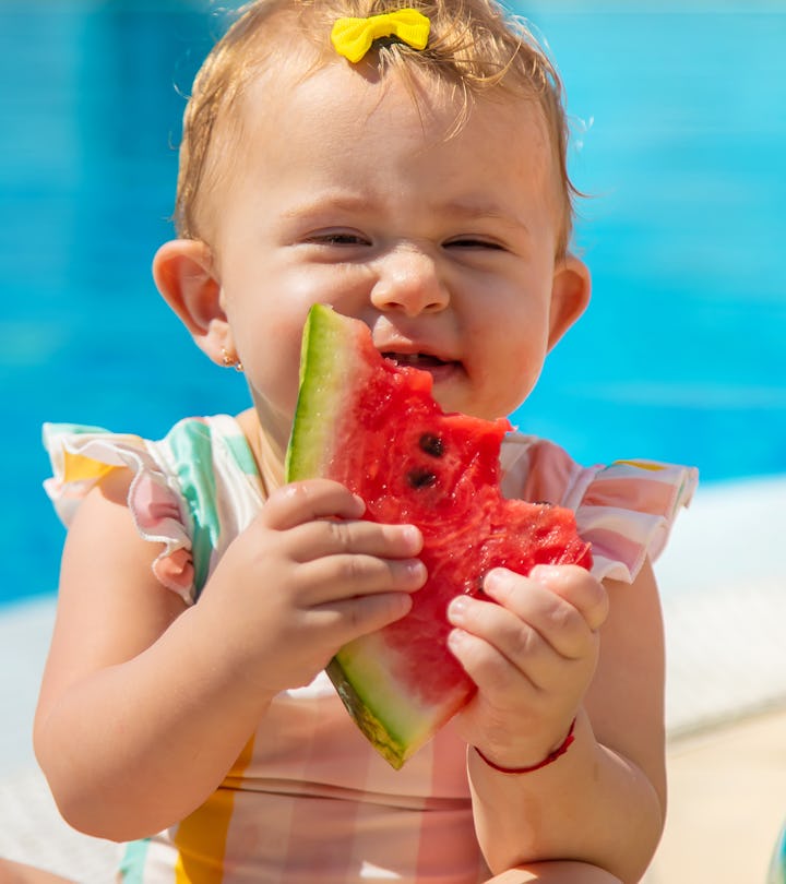 Baby is eating a watermelon by the pool, summer baby girl names