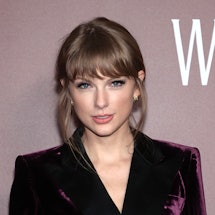 taylor swift wearing a velvet, double-breasted suit 