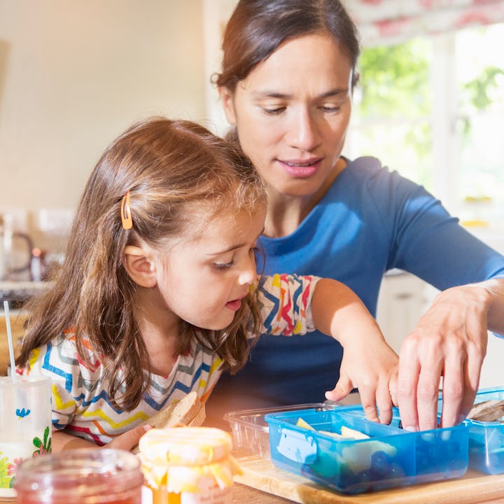 Mom packing a lunchbox with her daughter