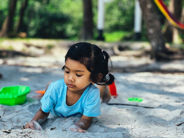 little girl playing in the sand, summer baby girl names